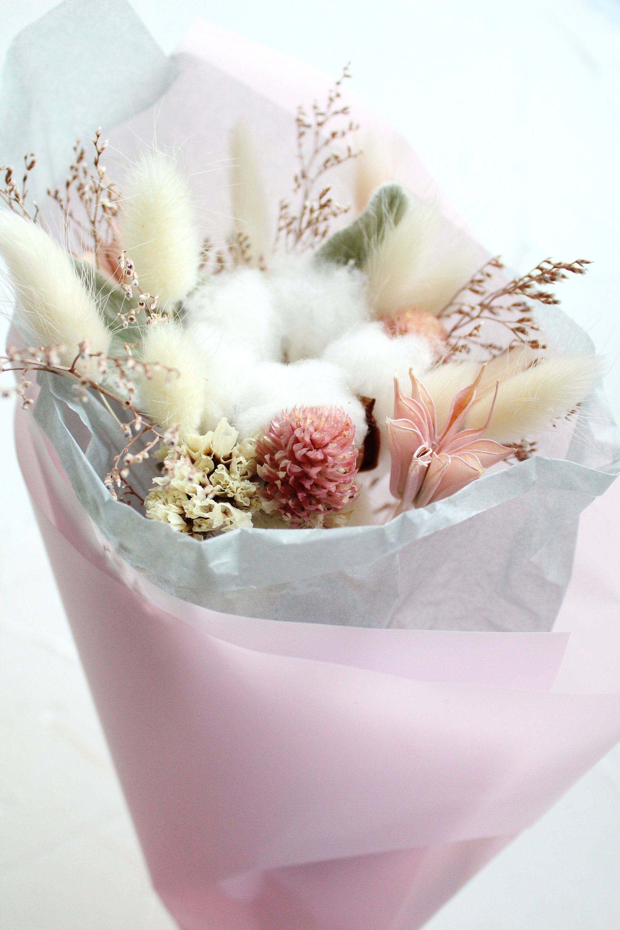 Small bride or bridesmaid wedding bouquet of dried flowers in green and pink colours